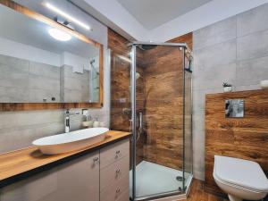 a bathroom with a sink and a glass shower at CLASSY APARTMENTS - AQUAPARK Reda II in Reda