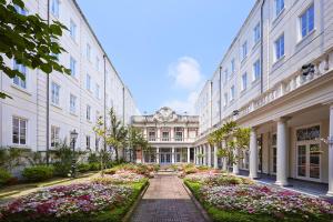 a walkway between two buildings with flowers at Hotel Amsterdam Huis Ten Bosch in Sasebo +37 photos