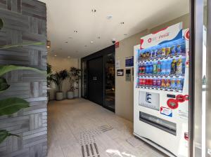 a vending machine in a building with drinks in it at ESLEAD HOTEL Osaka Tsuruhashi in Osaka