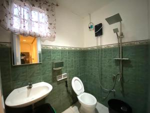 a bathroom with a shower and a toilet and a sink at Can accommodate up to 10 guest near Virac Airport in Virac