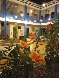 a lobby with flowers in the middle of a building at Celeste Villa de Leyva in Villa de Leyva