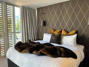 a bed with a large animal blanket on it at Eichardt's Private Hotel in Queenstown