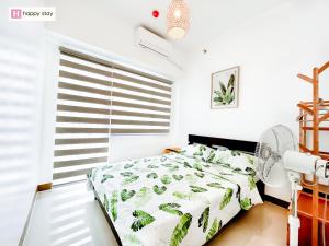 Ένα ή περισσότερα κρεβάτια σε δωμάτιο στο Happy Stay