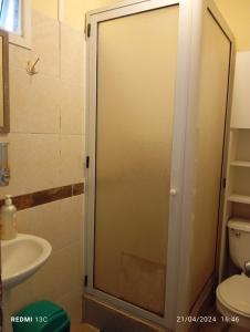 a glass shower door in a bathroom with a sink at Alojamiento jv CABAÑA in Nogales