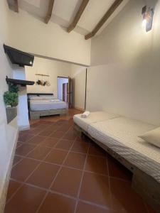 a bedroom with two beds in a room at Finca Hotel el Valhalla in Doradal