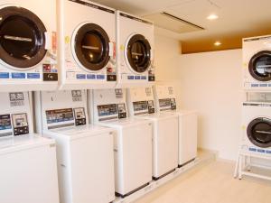 a row of washers and dryers in a laundry room at Kansai Airport Washington Hotel in Izumi-Sano