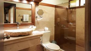 a bathroom with a sink and a toilet and a shower at Volcano Lodge, Hotel & Thermal Experience in Fortuna