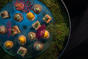 a blue plate with cookies and fruit on it at InterContinental Genève by IHG in Geneva
