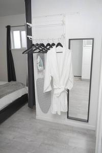 a white robe hanging in a room with a mirror at 2 Miles to Disneyland -FREE Parking! In Anaheim CA in Anaheim