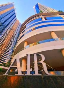 a large building with a sign on it with tall buildings at Kensal Industrial - Air Residences in Manila