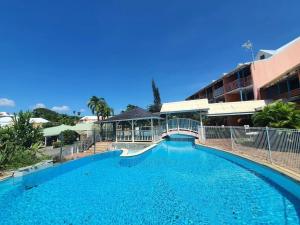 a large swimming pool in front of a building at Studio agréable à Sainte-Anne de 30 m² avec piscine partagée in Sainte-Anne +11 photos