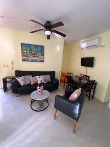 een woonkamer met een bank en een tafel bij paradise close to the beach pool free parking,wifi- punta cana in Punta Cana