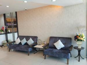 two chairs and a table in a waiting room at BG Business Hotel in Bukit Mertajam
