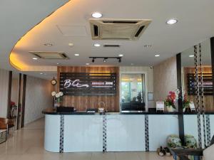 a lobby of a restaurant with a reception counter at BG Business Hotel in Bukit Mertajam