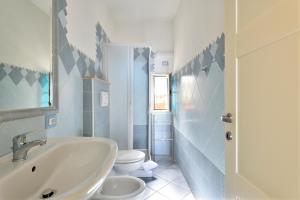 a bathroom with a sink and a toilet at Biriola EcoResort Cala Gonone in Cala Gonone