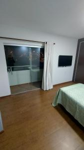 a bedroom with a large window with a view of the city at Hermoso y acogedor departamento in Sucre