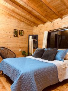 1 dormitorio con 1 cama en una cabaña de madera en Susurro del bosque, en Medellín
