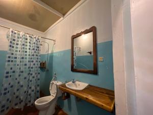 y baño con aseo, lavabo y espejo. en Afro Rooms & Tents in The Beach, en Kilindoni