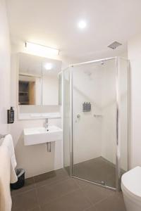 a bathroom with a shower and a sink at Ibis Darwin Airport Hotel in Darwin
