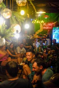 a group of people sitting in a bar at The Like Hostel & Cafe in Ho Chi Minh City