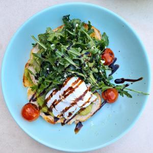 a plate of food with a sandwich and a salad at Novotel Darwin Airport in Darwin