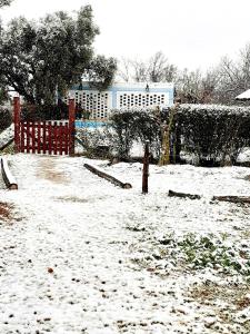 a snow covered yard with a fence and a building at Los Nogales in San Rafael