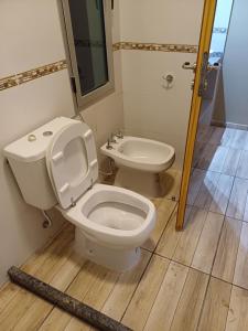 a bathroom with a toilet and a sink at Los Nogales in San Rafael