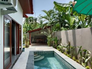 a swimming pool in the backyard of a house at Private Villa Aditya Beach in Pabean Buleleng
