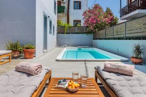 a patio with a pool and a table with a bowl of fruit at Forest view villa Skopelos in Skopelos Town