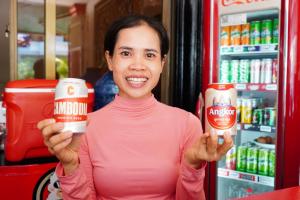 a woman holding up two cans of nutella at White Monkey in Siem Reap
