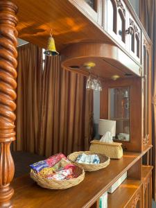 three baskets on a wooden counter in a room at Kp. เพลส หลวงแพ่ง (Kp. Place Luang Phaeng) in Ban Bang Bo