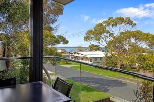 a view from the balcony of a house with a table and chairs at Sail Away Inlet Side in Inverloch