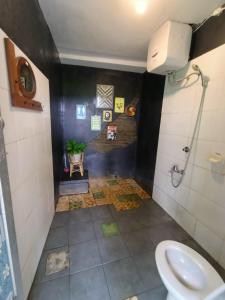 a bathroom with a toilet and a sink at VILLACANTIK Yogyakarta triple bed for six persons in Bantul