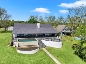 an aerial view of a house with a swimming pool at River Oaks Luxury Lakeshore Concierge Services Available in Kingsland