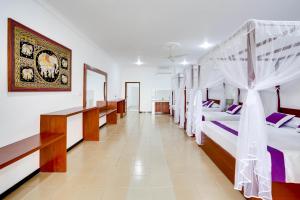 a room with four bunk beds in it at Treetop Resort By Scenery Villas in Dharga Town