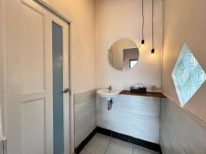a bathroom with a sink and a mirror at Sembalun Kita Cottage in Sembalun Lawang
