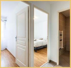 an open door leading to a bedroom with a bed at Chez Pierre / T3 / Etrembieres in Monnetier-Mornex