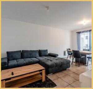 a living room with a couch and a table at Chez Pierre / T3 / Etrembieres in Monnetier-Mornex