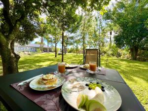 a table with plates of food and drinks on it at Summerfields & Gardens Lodge in Kitwe