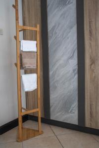 a towel ladder next to a wall with towels at Kata Station Boutique Hotel in Kata Beach