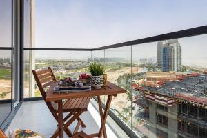 a table on a balcony with a view of a city at Frank Porter - Golf Vita in Dubai Marina