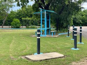 a park with a blue structure in the grass at Karumba Point Holiday & Tourist Park in Karumba