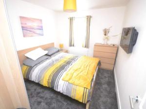 a bedroom with a bed and a tv in it at Cove Hideaway 1bhk Apt 10 in Skinningrove in Skinningrove