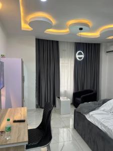 ポートハーコートにあるHighX Hotelsのベッドルーム1室(ベッド1台、テーブル、椅子付)