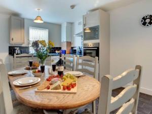 a kitchen and dining room with a wooden table with food on it at Skinningrove Apartment six in Skinningrove