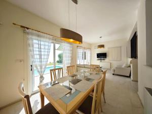 a dining room and living room with a table and chairs at Villa Rosalia in Coral Bay