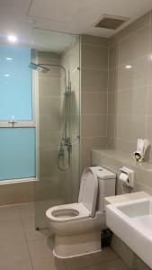 a bathroom with a toilet and a shower and a sink at Sutera Avenue Kota Kinabalu in Kota Kinabalu