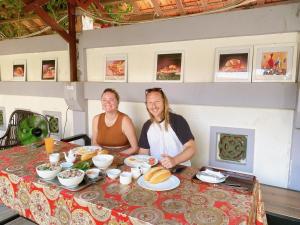 a man and woman sitting at a table with food at Golden Star Villa Hue in Hue