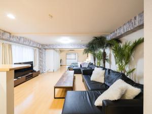 a living room with couches and a tv at Shinjuku, 1min walk from Kagurazaka Sta ,80square meters,net, PocketWiFi, Switch in Tokyo