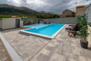 a swimming pool on the roof of a house at Relax House Rosemary in Draga Bašćanska